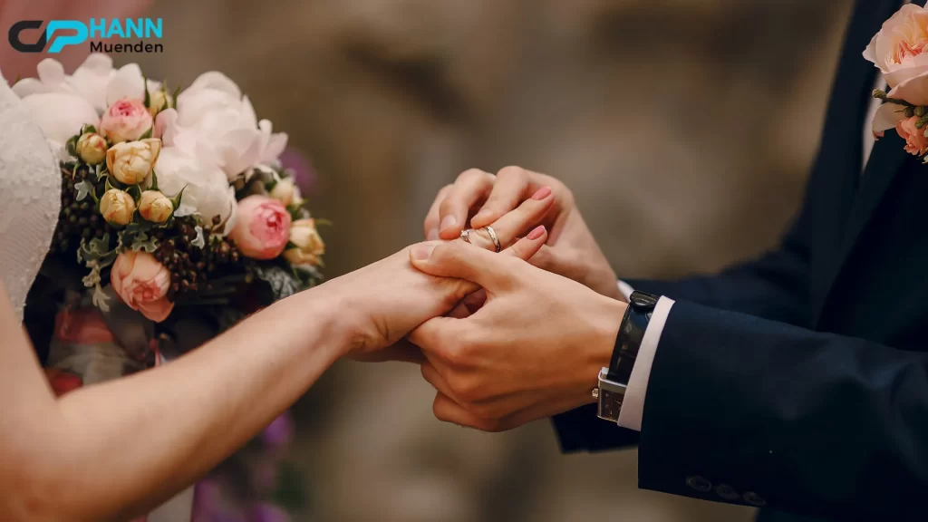 "Can You Get Invited to a Wedding? A groom places a wedding ring on the bride’s finger, symbolizing love and commitment."